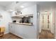Open kitchen with breakfast bar, white cabinets, granite countertops, and modern stainless-steel appliances at 3815 Ne 17Th Street Cir, Ocala, FL 34470