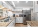 Bright kitchen features white cabinets, granite countertops, and stainless steel appliances with wood flooring at 3815 Ne 17Th Street Cir, Ocala, FL 34470