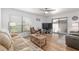 Spacious living room with wood floors, a ceiling fan, and access to the outdoor patio at 3815 Ne 17Th Street Cir, Ocala, FL 34470
