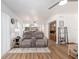 Open-concept living space with wood floors, seamless transition to the kitchen, and modern furnishings at 3815 Ne 17Th Street Cir, Ocala, FL 34470