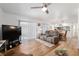 Bright living room featuring wood floors, modern furnishings, and sliding door to outdoor patio at 3815 Ne 17Th Street Cir, Ocala, FL 34470