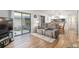 Bright living room featuring wood floors, modern furnishings, and sliding door to outdoor patio at 3815 Ne 17Th Street Cir, Ocala, FL 34470