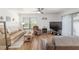 Comfortable living room with wood floors, a ceiling fan, and plenty of natural light at 3815 Ne 17Th Street Cir, Ocala, FL 34470