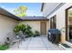 Secluded patio with outdoor seating, lush plants, and BBQ grill for outdoor enjoyment at 3815 Ne 17Th Street Cir, Ocala, FL 34470