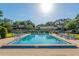 Community pool surrounded by lounge chairs and well-maintained landscaping offers a relaxing outdoor space at 3815 Ne 17Th Street Cir, Ocala, FL 34470