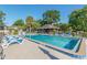 Community pool featuring a covered lounge area for shade and relaxation on a sunny day at 3815 Ne 17Th Street Cir, Ocala, FL 34470