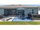Backyard view featuring patio with seating, hot tub and screen porch at 4064 Sw 132Nd Ln, Ocala, FL 34473