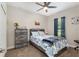 Cozy bedroom featuring a patterned bedspread, gray furniture, ceiling fan, and carpeted floors at 4064 Sw 132Nd Ln, Ocala, FL 34473