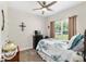 This bedroom boasts a ceiling fan and a large window with green backyard views at 4064 Sw 132Nd Ln, Ocala, FL 34473