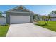 Well-maintained home features a two-car garage and a green lawn at 4064 Sw 132Nd Ln, Ocala, FL 34473