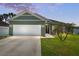 Charming single-story home with a well-manicured lawn and two-car garage at 4064 Sw 132Nd Ln, Ocala, FL 34473