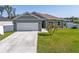 Charming single Gathering home features a large front yard and a two car garage at 4064 Sw 132Nd Ln, Ocala, FL 34473