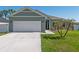 Well-maintained home features a two-car garage and a green lawn at 4064 Sw 132Nd Ln, Ocala, FL 34473