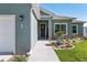 The front door is framed by charming landscaping and a stone walkway at 4064 Sw 132Nd Ln, Ocala, FL 34473