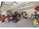 This garage has a motorcycle, lawn equipment, storage, and ample open space at 4064 Sw 132Nd Ln, Ocala, FL 34473
