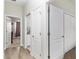 Hallway with doorways leading to the bedroom and bathroom, featuring white doors and light wood flooring at 4064 Sw 132Nd Ln, Ocala, FL 34473