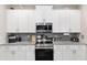 Close-up of kitchen featuring modern appliances, subway tile backsplash, and granite countertops at 4064 Sw 132Nd Ln, Ocala, FL 34473