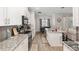 Open-concept kitchen with granite countertops, stainless steel appliances, and adjacent dining area at 4064 Sw 132Nd Ln, Ocala, FL 34473