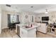 Bright, open kitchen with island seating, stainless steel appliances, and a view of the living area at 4064 Sw 132Nd Ln, Ocala, FL 34473