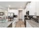 Modern kitchen featuring granite countertops, stainless steel appliances, and white cabinetry at 4064 Sw 132Nd Ln, Ocala, FL 34473