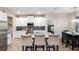 Bright, open kitchen with white cabinets, granite countertops, and seating at the island at 4064 Sw 132Nd Ln, Ocala, FL 34473