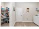 Spacious laundry room includes a pantry, shelving, and a modern washer and dryer at 4064 Sw 132Nd Ln, Ocala, FL 34473