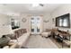 Cozy living room with plush seating, natural light, and access to the outdoor space at 4064 Sw 132Nd Ln, Ocala, FL 34473