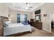 Serene main bedroom boasts tray ceilings, a ceiling fan, and a cozy seating area at 4064 Sw 132Nd Ln, Ocala, FL 34473