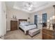 Comfortable main bedroom featuring a tray ceiling, ceiling fan, and abundant natural light at 4064 Sw 132Nd Ln, Ocala, FL 34473