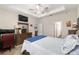 Bright main bedroom with a ceiling fan, TV, and en-suite bathroom access at 4064 Sw 132Nd Ln, Ocala, FL 34473