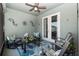 The screened patio is furnished with a ceiling fan and comfortable rocking chairs at 4064 Sw 132Nd Ln, Ocala, FL 34473