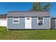 Exterior view of gray and white shed with white door at 4064 Sw 132Nd Ln, Ocala, FL 34473