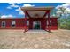 View of the back of the home with a patio, ceiling fan, and sliding glass doors to the interior at 4312 Sw 172Nd Place Rd, Ocala, FL 34473
