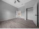 Bedroom featuring grey walls, wood-look flooring, walk-in closet, and ceiling fan at 4312 Sw 172Nd Place Rd, Ocala, FL 34473