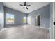 Large bedroom features a ceiling fan, and a view of the neighborhood, adjacent bathroom and walk-in closet at 4312 Sw 172Nd Place Rd, Ocala, FL 34473