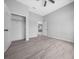 Bedroom featuring grey walls, wood-look flooring, walk-in closet, and ceiling fan at 4312 Sw 172Nd Place Rd, Ocala, FL 34473
