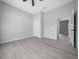 Bedroom featuring grey walls, wood-look flooring, walk-in closet, and ceiling fan at 4312 Sw 172Nd Place Rd, Ocala, FL 34473