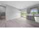 Bright dining area with grey cabinets, stainless sink, sliding door access to backyard and modern light fixture at 4312 Sw 172Nd Place Rd, Ocala, FL 34473