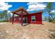 Rear exterior elevation of the red home showing the covered patio and new construction at 4312 Sw 172Nd Place Rd, Ocala, FL 34473