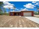 Charming one-story home with a two-car garage, red siding, and a well-manicured lawn at 4312 Sw 172Nd Place Rd, Ocala, FL 34473