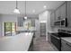 Modern kitchen with gray cabinetry, stainless appliances, island and walkout access to backyard at 4312 Sw 172Nd Place Rd, Ocala, FL 34473