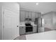 Modern kitchen with stainless steel appliances, gray cabinets, and a subway tile backsplash at 4312 Sw 172Nd Place Rd, Ocala, FL 34473
