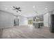 Open-concept living room with grey cabinets, island, stainless appliances, and sliding door access to backyard at 4312 Sw 172Nd Place Rd, Ocala, FL 34473