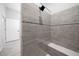Contemporary walk-in shower with gray tiling, sleek fixtures, shower bench, and contrasting mosaic tile floor at 4312 Sw 172Nd Place Rd, Ocala, FL 34473