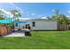 Inviting backyard with a wooden deck, above ground pool, and a well-maintained lawn at 46 Fisher Lane Ter, Ocklawaha, FL 32179