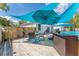 Outdoor deck with above ground pool, patio table and string lights at 46 Fisher Lane Ter, Ocklawaha, FL 32179