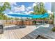Outdoor deck with above ground pool, patio table, outdoor grill, and string lights at 46 Fisher Lane Ter, Ocklawaha, FL 32179