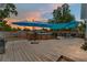 Outdoor deck with above ground pool, patio table, outdoor grill, and string lights at 46 Fisher Lane Ter, Ocklawaha, FL 32179