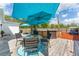 Outdoor deck with above ground pool, patio table and string lights at 46 Fisher Lane Ter, Ocklawaha, FL 32179