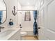 Bright bathroom features a shower-tub combination with nautical-themed decor at 46 Fisher Lane Ter, Ocklawaha, FL 32179